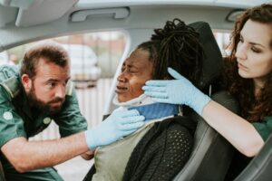 Black woman in car accident with neck brace after whiplash injury