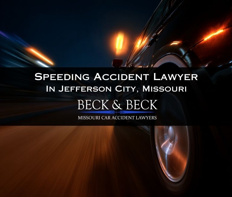 Close up of an SUV driving so fast that it is a blur on a Missouri highway at night