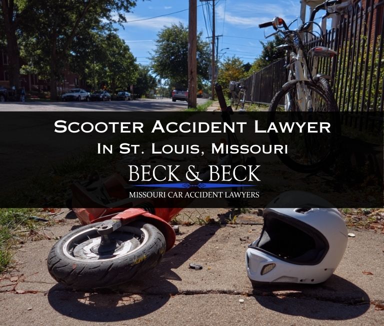 Crashed scooter on its side with a bicycle helmet next to it on a sidewalk in st louis missouri