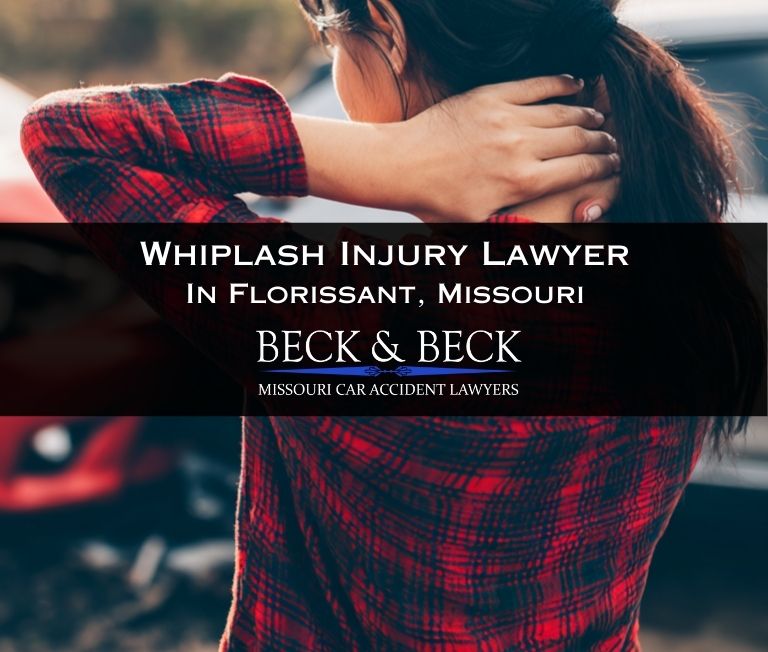 Woman holding the back of her neck in pain next to her crashed car after an accident in Florissant, Missouri