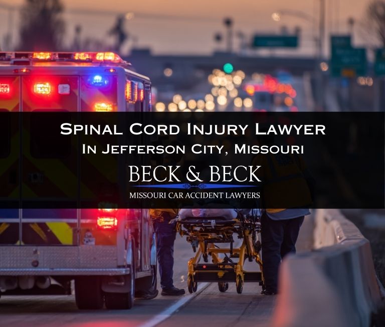 Man on gurney with spinal cord injury after a car accident, EMTs loading victim into ambulance in Jefferson City, Missouri