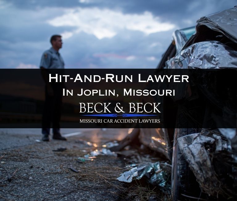 Driver standing next to his crashed car on highway in Joplin, Missouri related to a case handled by Missouri Car Accident Lawyers
