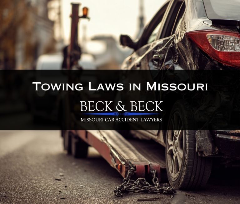 Crashed car being towed from an intersection in St. Louis, Missouri