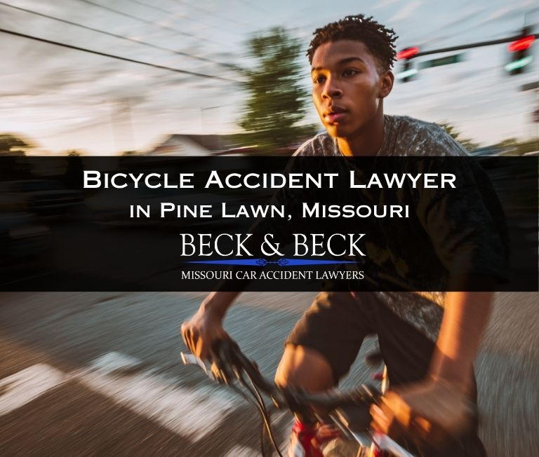 Teenager on a bicycle crossing a street in Pine Lawn, Missouri.