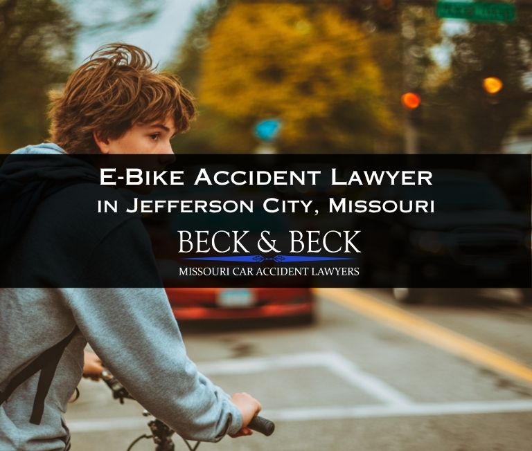 Teenager on bicycle crossing the road in heavy traffic in Jefferson City, Missouri