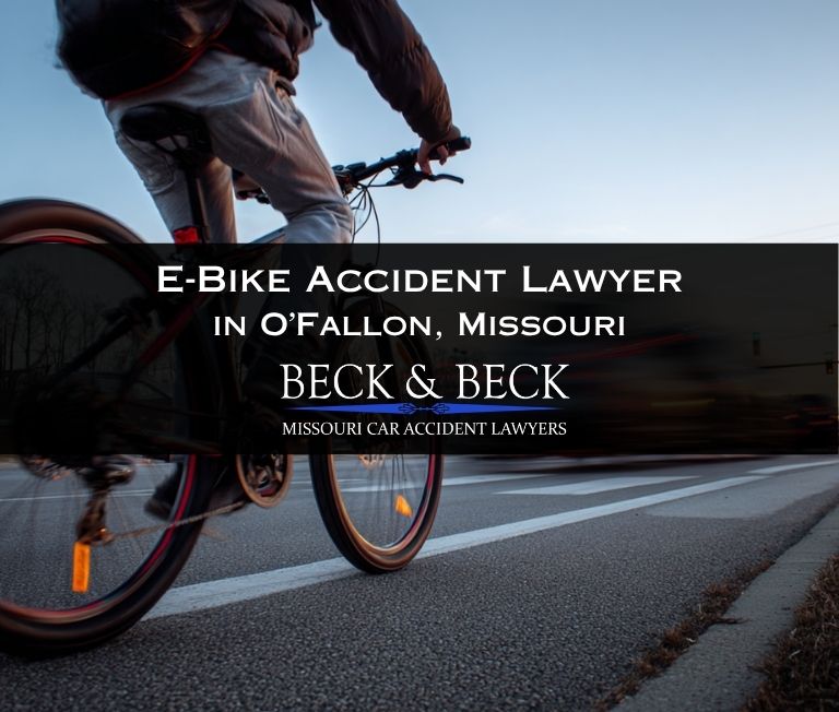 Teenager on an e-bike crossing the road with traffic behind him in O'Fallon, Missouri