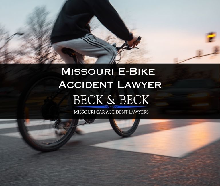 Teenager on an e-bike crossing the road in heavy traffic in St. Louis, Missouri