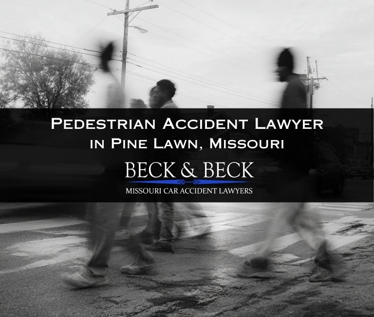 Pedestrians crossing the street with the blur of cars behind them in Pine Lawn, Missouri