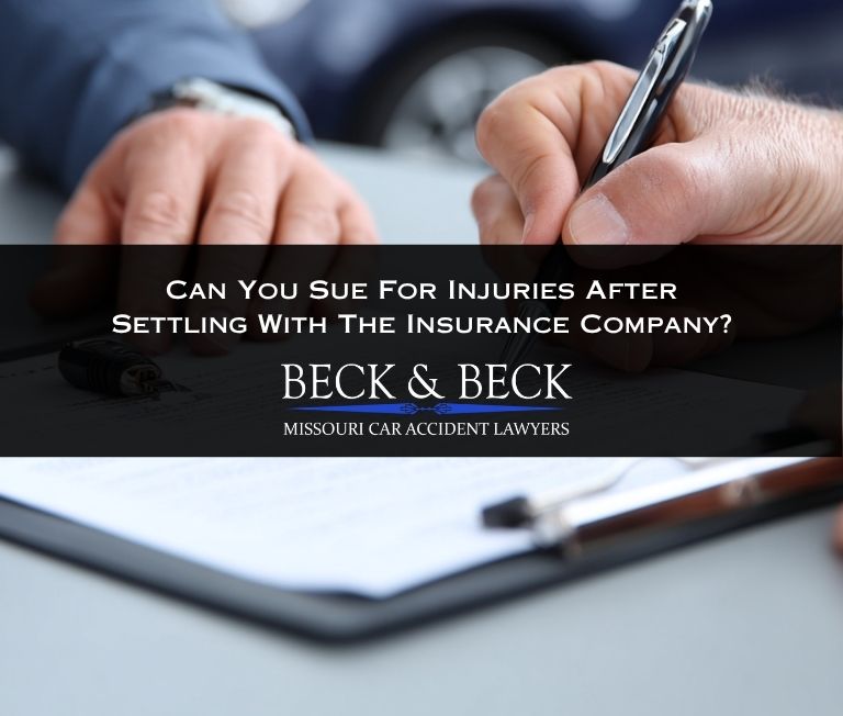 Car accident victim signing a settlement release with the at-fault driver's insurance company in Missouri