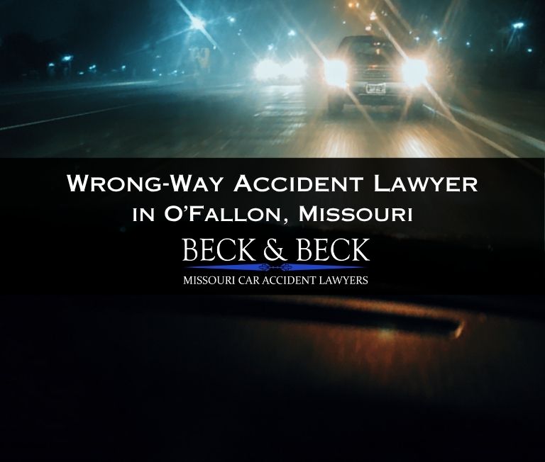 Photo from inside of a car of the headlights of an oncoming car directly in front of you, nighttime in O'Fallon, MO