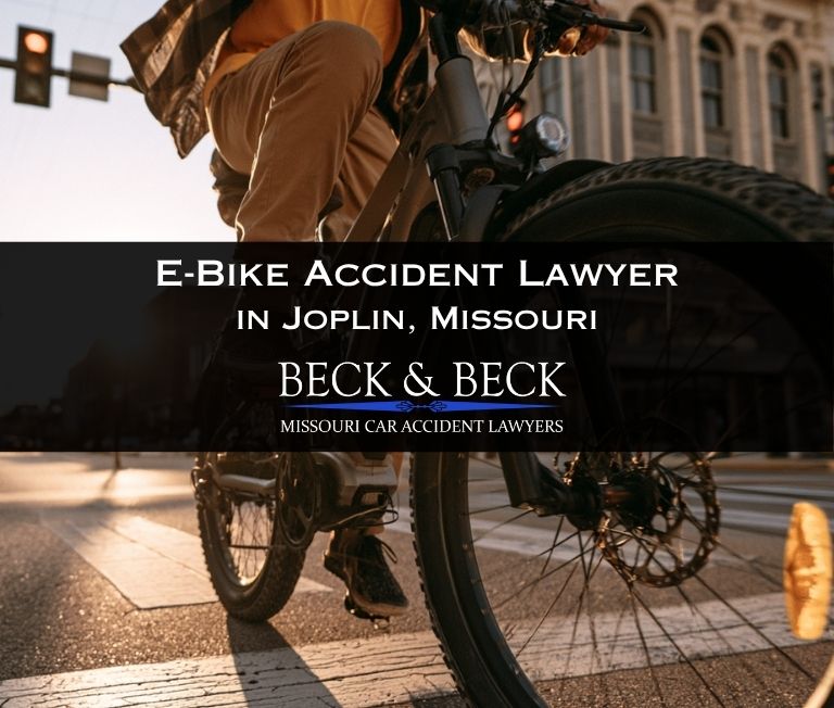 Teenager on an e-bike crossing the road in downtown Joplin, Missouri related to a case handled by Beck & Beck Missouri Car Accident Lawyers