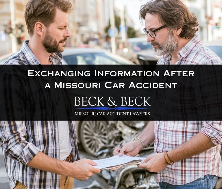 Two drivers exchanging information after a car accident in St. Louis, Missouri