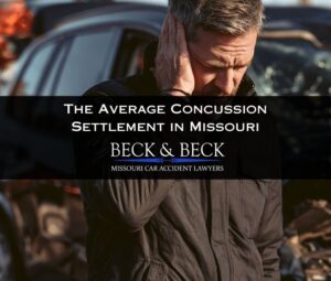 Man standing next to his crashed car holding his head in pain in Missouri