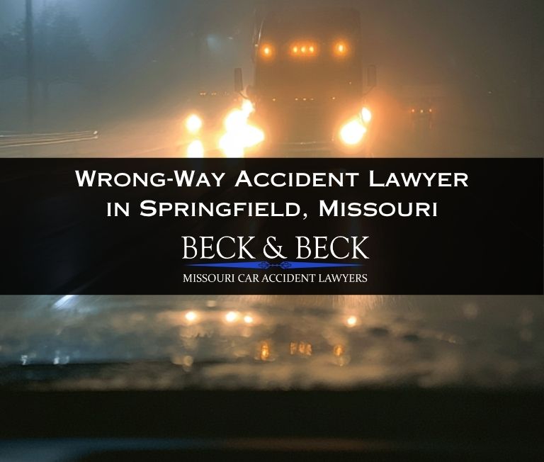 View from inside of a car of the headlights of a semi-truck directly in front of them, nighttime in Springfield, Missouri