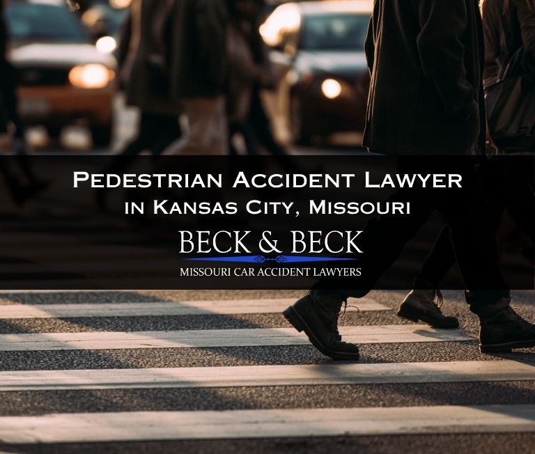 Pedestrians in a crosswalk in Kansas City, Missouri, blurred traffic behind them