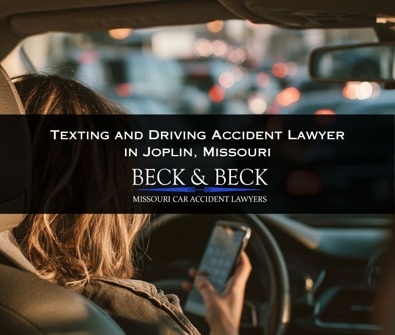 Woman texting while driving in heavy traffic in Joplin, Missouri