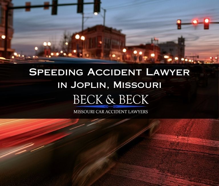 Speeding car running a red light at night in Joplin, Missouri