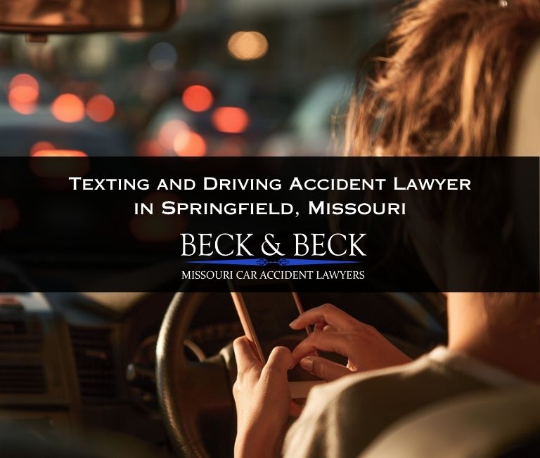 Woman texting while driving in traffic in downtown Springfield, Missouri