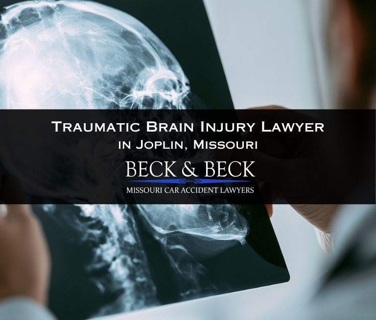 Doctor examining x-ray of car accident victims skull in Joplin, Missouri