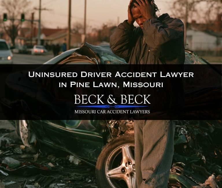 Man standing next to his crashed car after being hit by an uninsured driver in Pine Lawn, Missouri