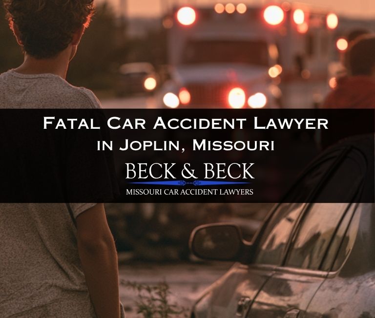 Onlookers observing car accident scene involving a fatality in Joplin, Missouri, ambulance approaching from distance