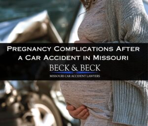 Pregnant woman standing next to her crashed car in Missouri, she has her hands on her stomach